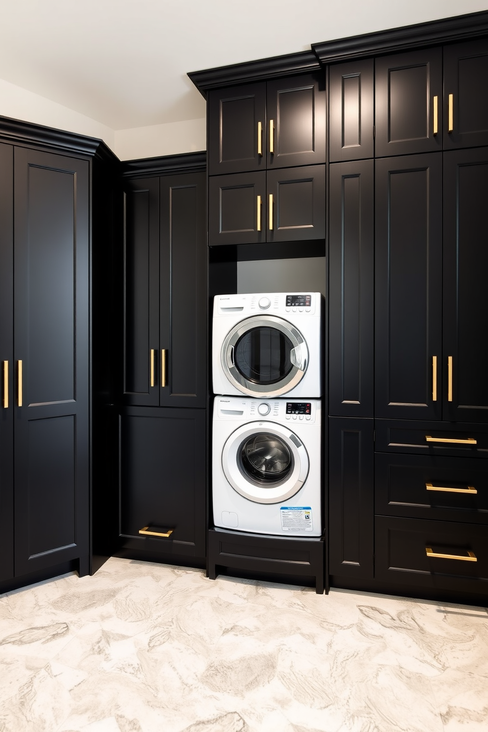 A sleek black laundry room features cabinets with elegant gold hardware that add a touch of sophistication. The space is well-organized with a modern washer and dryer seamlessly integrated into the cabinetry, providing a clean and functional aesthetic.