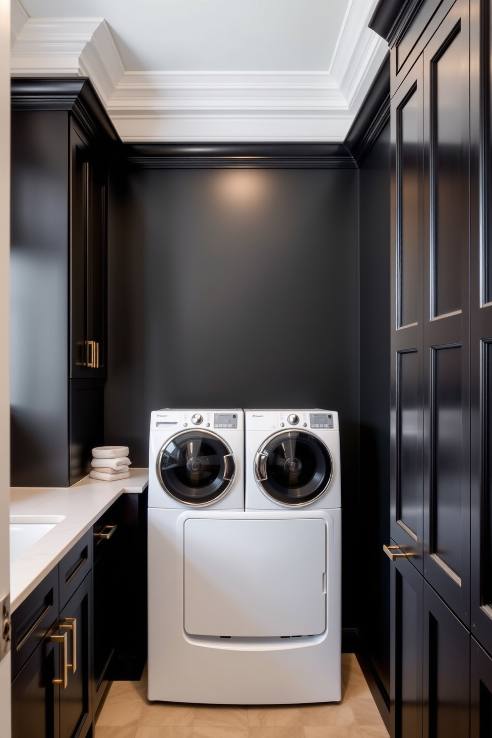 Crown molding adds an elegant finish to the laundry room, enhancing the overall aesthetic with its classic appeal. The space features sleek black cabinetry with gold hardware, providing a modern yet sophisticated look. The walls are painted in a deep matte black, creating a dramatic backdrop for the white appliances. A stylish countertop in a contrasting light color offers ample space for folding laundry and organizing supplies.