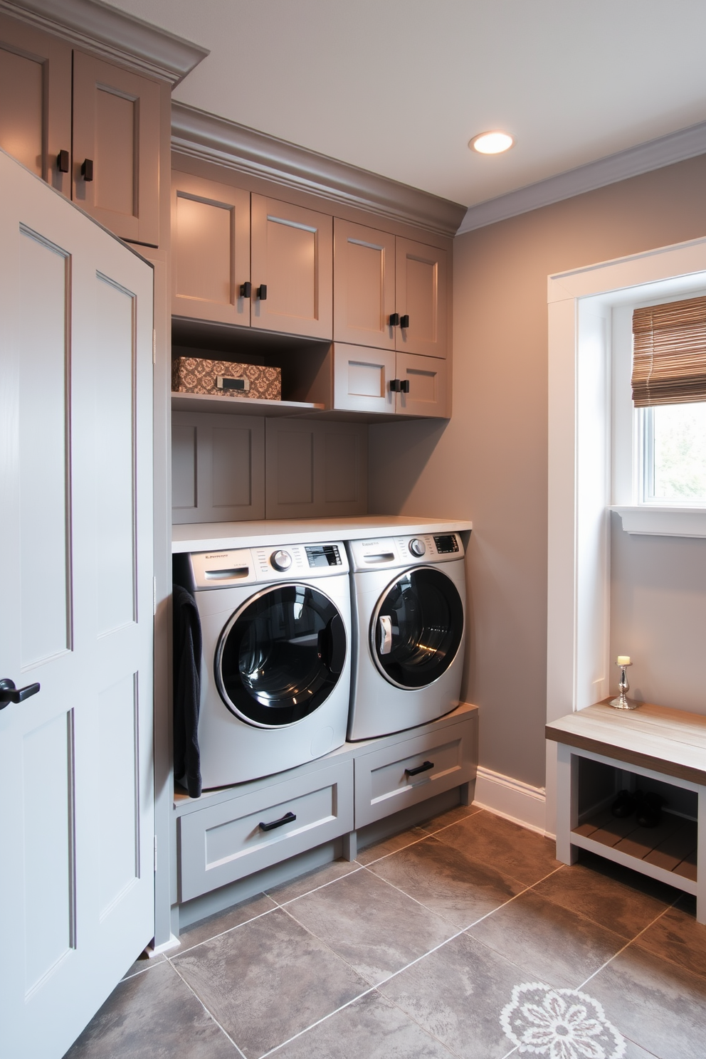 A functional mudroom entry designed with a dedicated laundry space features built-in cabinetry for storage and organization. The walls are painted in a soft gray tone, complemented by a durable tile floor that withstands heavy foot traffic. The laundry area includes a modern washer and dryer stacked for efficiency, with a folding countertop above. Accent lighting highlights the space, and a bench with hooks provides a welcoming area for coats and bags.