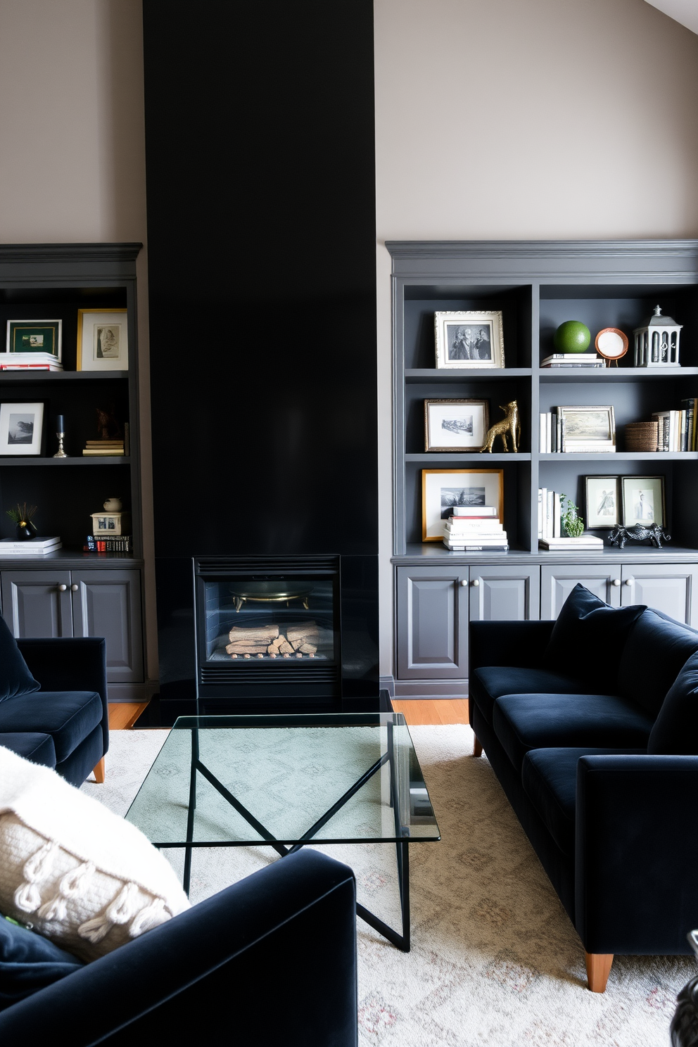 A sophisticated black fireplace serves as the focal point of the living room, surrounded by elegant built-in shelves filled with curated decor. The walls are painted in a soft gray hue, while plush black velvet sofas create a cozy seating area, complemented by a sleek glass coffee table at the center.