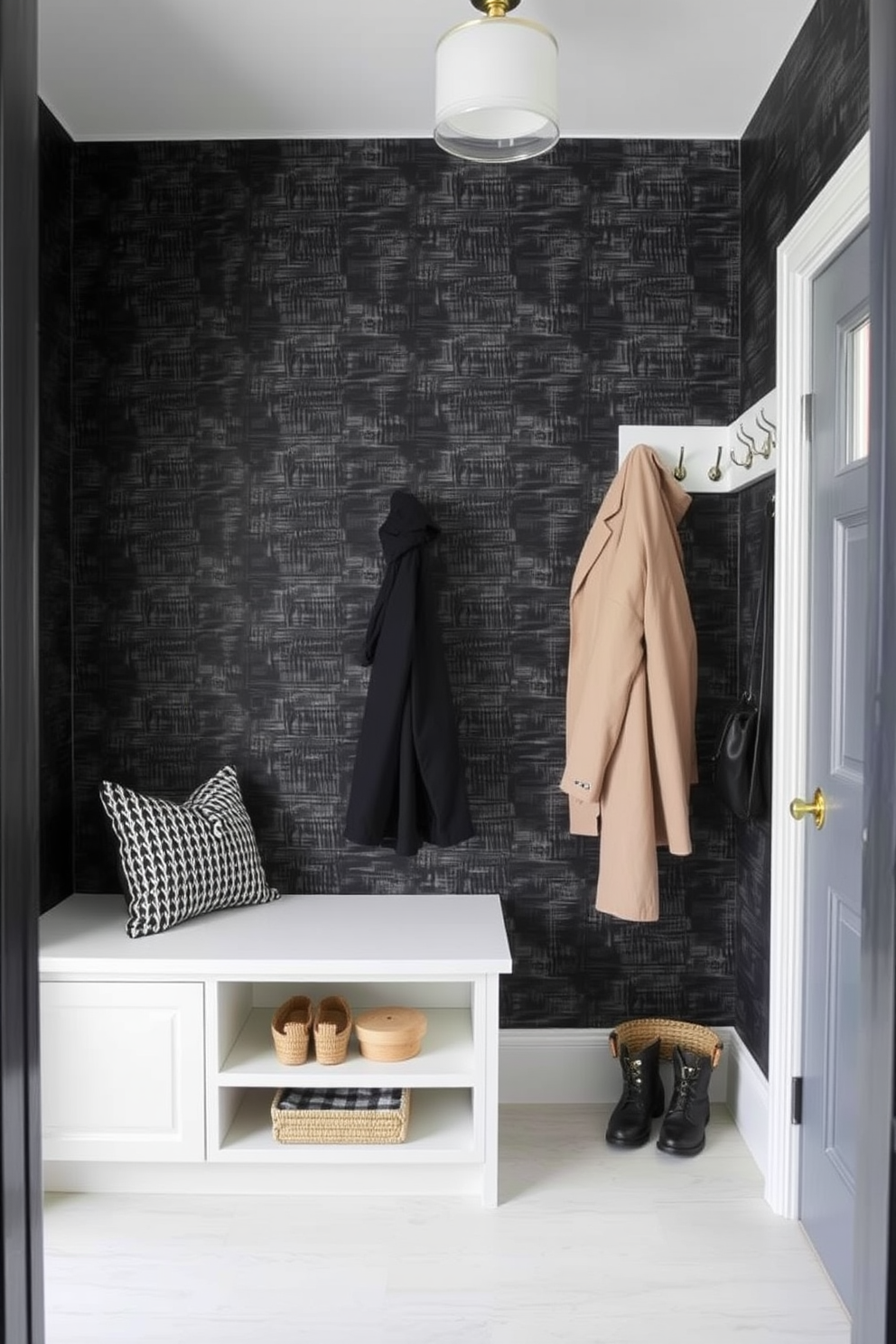 A stylish black and gray patterned rug lies at the entrance of a modern mudroom. The space features built-in wooden benches with storage underneath and hooks for coats on the wall. Natural light floods in through a large window, highlighting the sleek design of the room. The walls are painted in a crisp white, creating a fresh and inviting atmosphere.