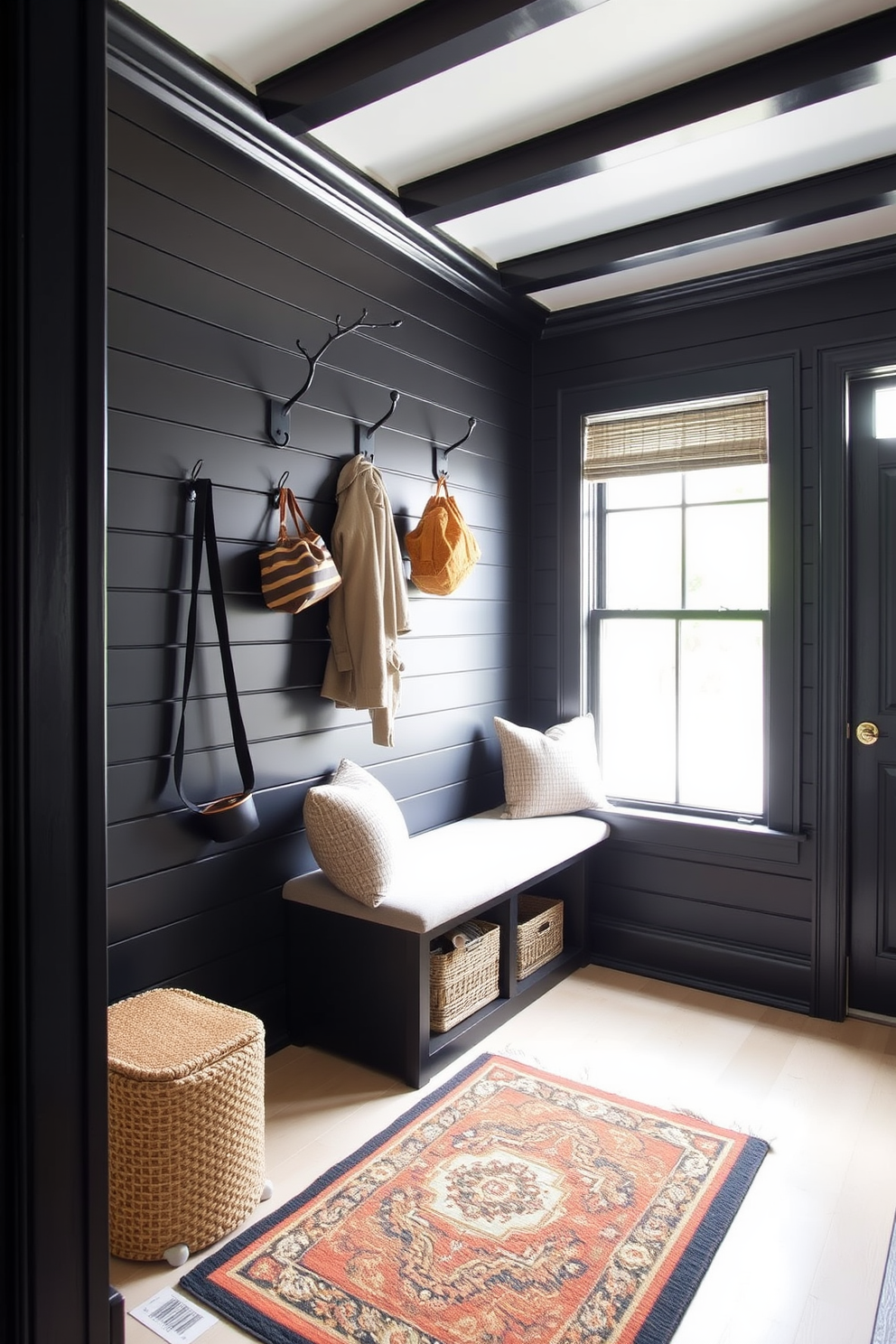 A stylish mudroom features black painted beadboard walls that create a striking contrast with the light-colored flooring. The space is adorned with a built-in bench upholstered in a neutral fabric, providing a comfortable spot to sit while removing shoes. Above the bench, sleek black hooks are mounted for hanging coats and bags, adding both functionality and style. A large window allows natural light to flood the room, illuminating a decorative rug that adds warmth and texture to the space.