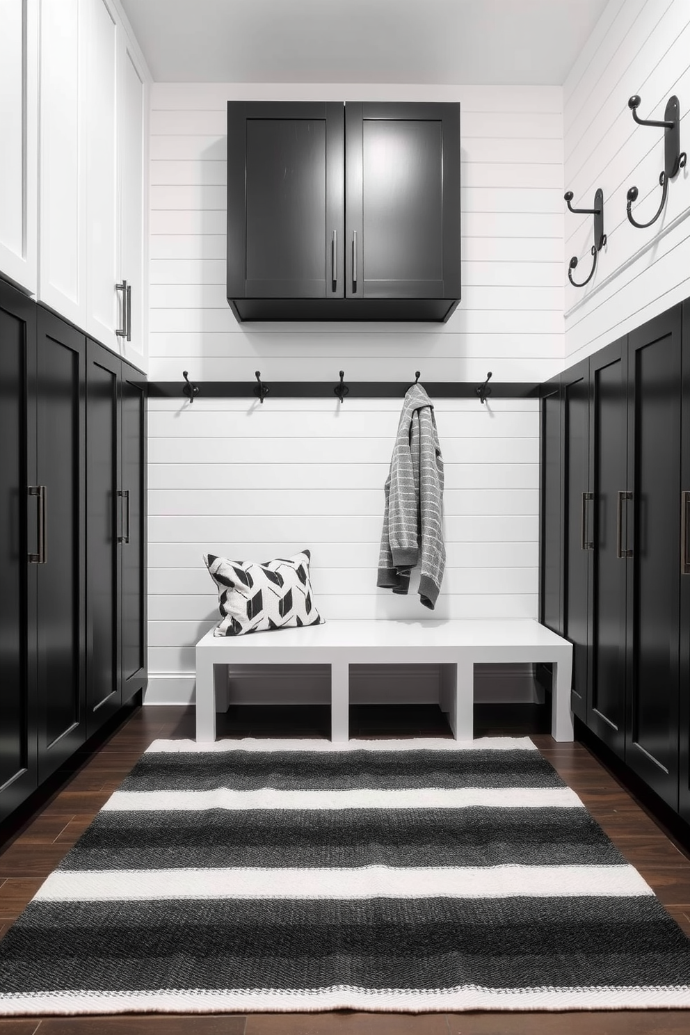 Chic black and white striped rug. The rug is placed in the center of a modern mudroom, complementing the sleek cabinetry and stylish hooks on the walls. Black mudroom design ideas. The space features a combination of matte black cabinets and white shiplap walls, creating a striking contrast that enhances the overall aesthetic.