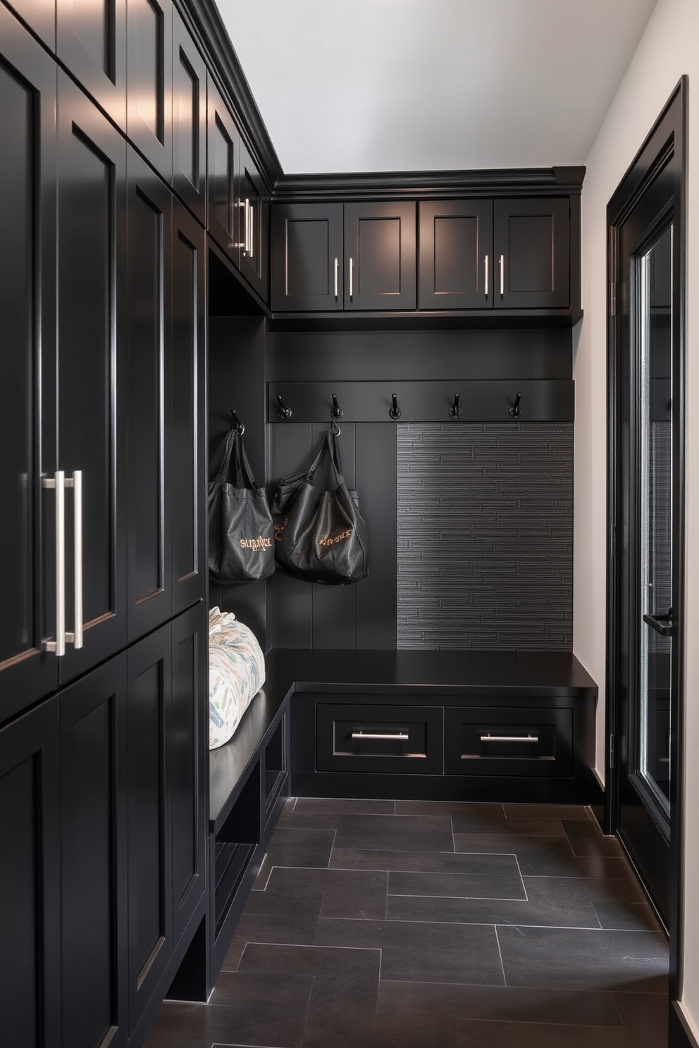 A functional drop zone features sleek black finishes with a built-in bench for seating. The space includes hooks for hanging coats and bags, complemented by a stylish black cabinet for storage. The mudroom design showcases a combination of black cabinetry and textured wall panels. A durable floor in a dark hue adds to the modern aesthetic while providing practicality for high-traffic use.