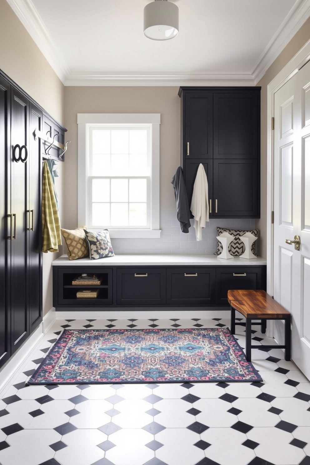 A stylish mudroom featuring a contrast of black and white tile flooring. The space includes a built-in bench with storage underneath and hooks above for coats and bags. Natural light floods the room through a large window, highlighting the sleek cabinetry in a matte black finish. A vibrant area rug adds a pop of color, complementing the overall design aesthetic.