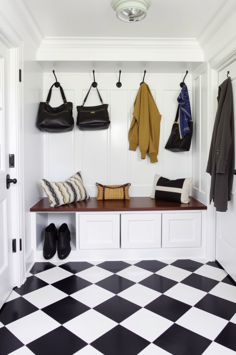 A stylish mudroom featuring a classic black and white checkerboard floor that adds a timeless elegance. The space includes a built-in bench with storage underneath and hooks above for coats and bags, all framed by crisp white wainscoting.