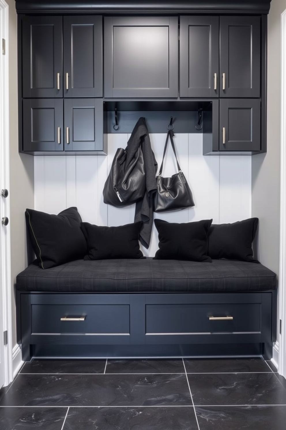 A striking mudroom featuring bold black wallpaper adorned with geometric patterns. The space includes a built-in bench with plush cushions and hooks for hanging coats and bags.