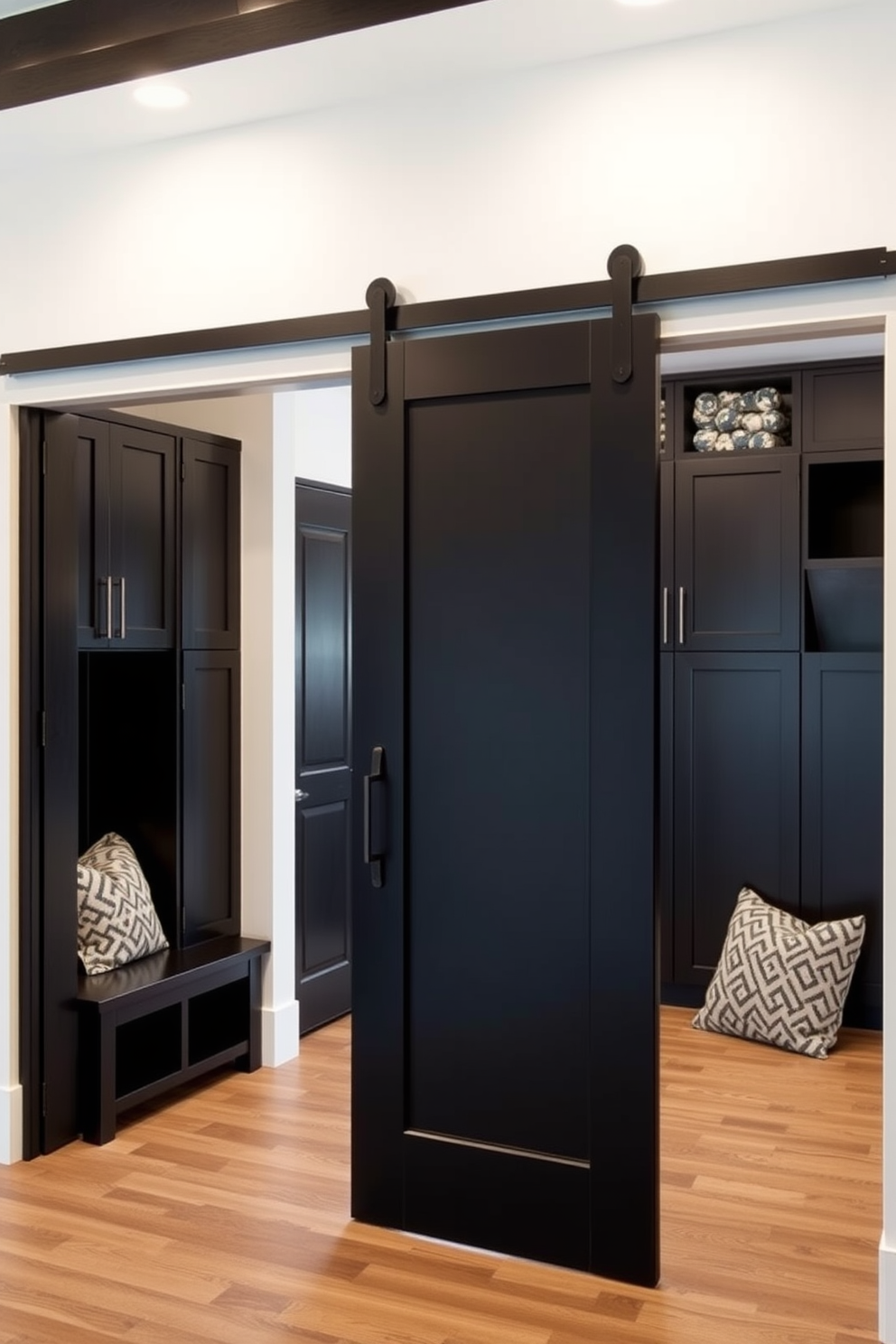 A striking black sliding barn door serves as the entryway, seamlessly blending modern aesthetics with rustic charm. The door's sleek design enhances the overall ambiance, inviting guests into a stylish space. The mudroom features a functional layout with built-in storage solutions, including benches and cubbies. Dark cabinetry complements the black sliding barn door, creating a cohesive and inviting atmosphere.