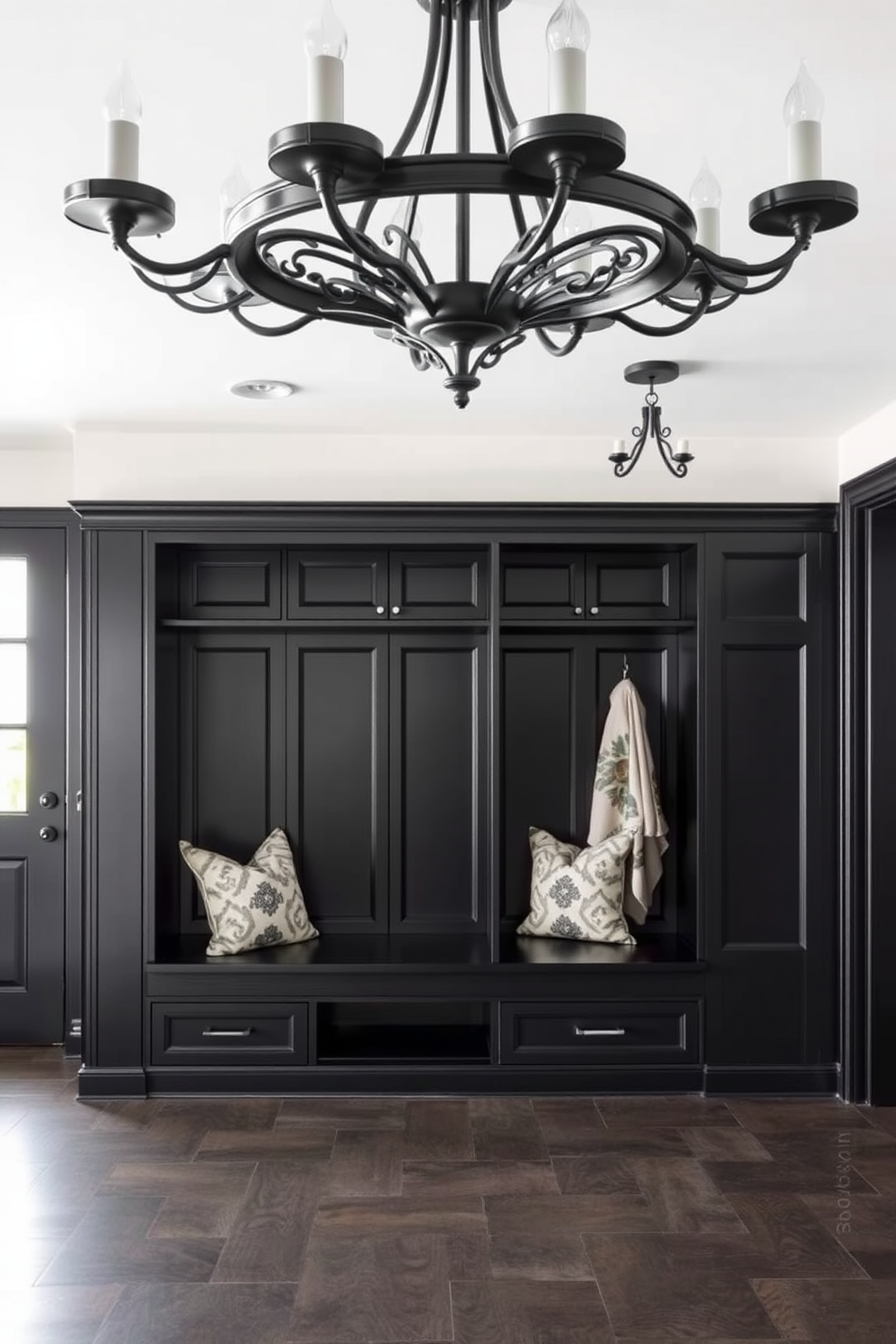 A stylish mudroom featuring elegant black pendant lighting fixtures suspended from the ceiling. The space is designed with a combination of black cabinetry and white shiplap walls, creating a modern yet welcoming atmosphere.