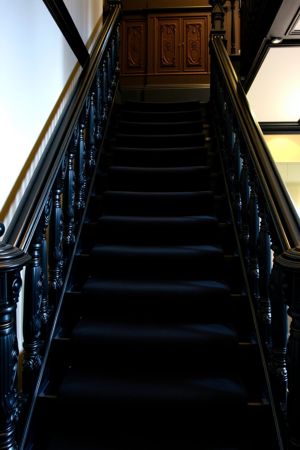 A striking black staircase ascends gracefully, featuring a sleek glass balustrade that enhances its modern aesthetic. The juxtaposition of the deep black steps against the transparent glass creates an open and airy feel in the space. The staircase is illuminated by strategically placed recessed lighting, highlighting its elegant lines and contours. Below, a minimalist console table complements the design, adding a touch of functionality without detracting from the staircase's visual impact.