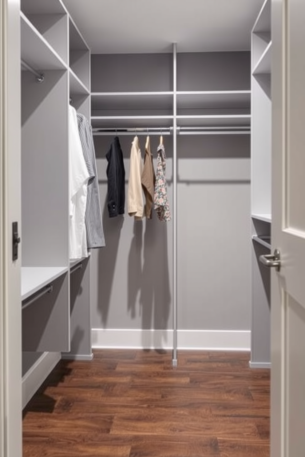 A modern walk-in closet featuring hanging racks with adjustable heights for versatile storage options. The walls are painted in a soft gray, and the floor is covered with sleek dark wood planks for an elegant touch.