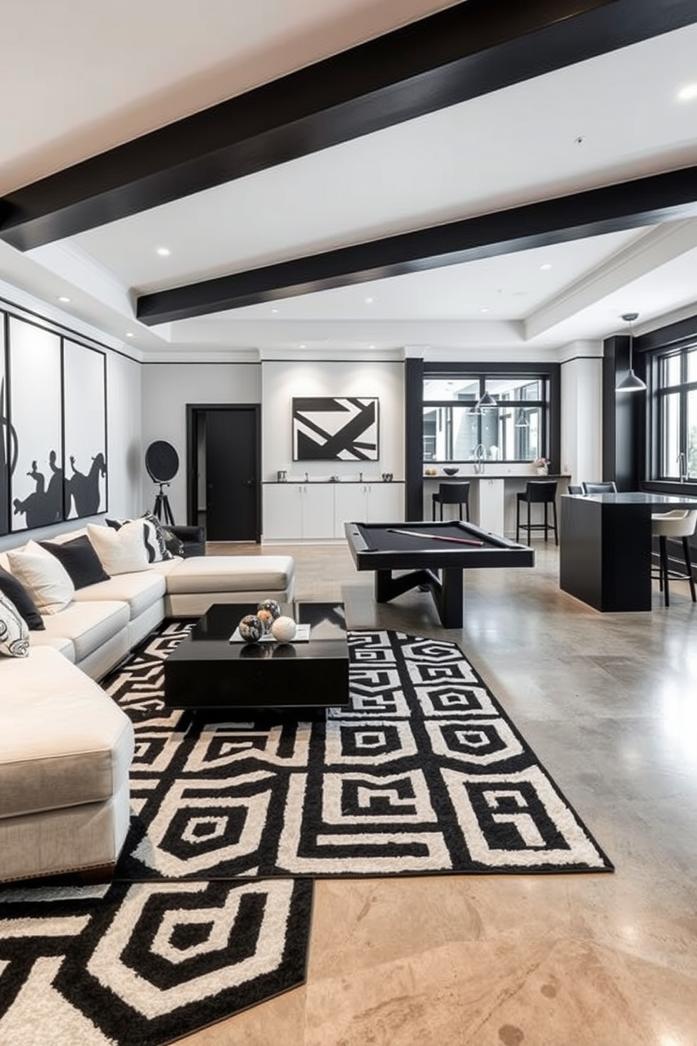 A spacious game room designed in black and white features a large sectional sofa with plush cushions facing a sleek coffee table. The walls are adorned with black and white artwork, and a stylish pool table occupies the center of the room, complemented by modern pendant lighting overhead. The basement design incorporates a polished concrete floor with a striking black and white geometric rug. A small bar area with high stools and a minimalist design adds functionality, while large windows provide natural light, enhancing the open feel of the space.