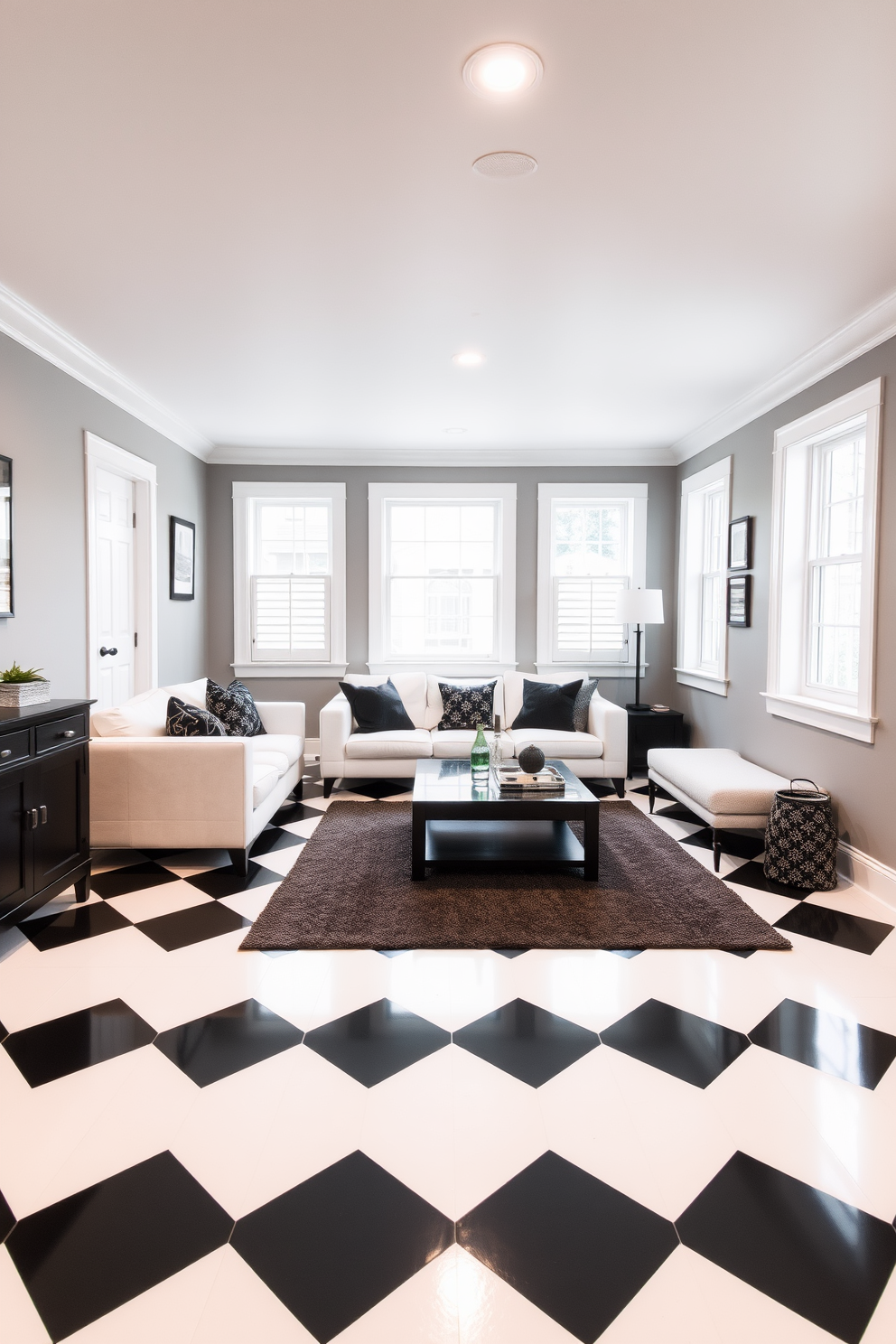 A stylish basement featuring classic black and white checkerboard flooring that creates a striking visual contrast. The walls are painted in a soft gray, complementing the bold floor while modern furnishings add a touch of elegance. A cozy seating area is arranged with a plush white sectional sofa and a sleek black coffee table at the center. Large windows allow natural light to flood the space, enhancing the timeless black and white theme.