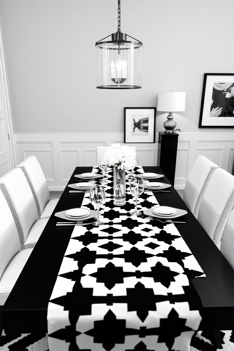 A striking black and white dining room features a large rectangular table with a glossy black finish surrounded by elegant white upholstered chairs. Above the table, bold black light fixtures with Edison bulbs create a warm and inviting atmosphere while adding a touch of industrial charm. The walls are adorned with monochromatic artwork, enhancing the sophisticated aesthetic of the space. A plush area rug in contrasting patterns anchors the room, providing comfort and style underfoot.