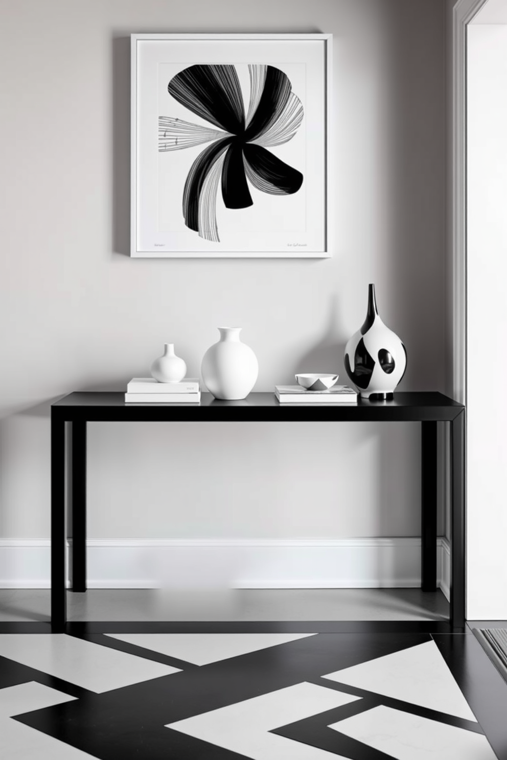 A sleek black console table stands against the wall, adorned with minimalist white decor items that create a striking contrast. The foyer features a monochromatic theme with black and white elements, including geometric patterns on the floor and elegant wall art that enhances the modern aesthetic.