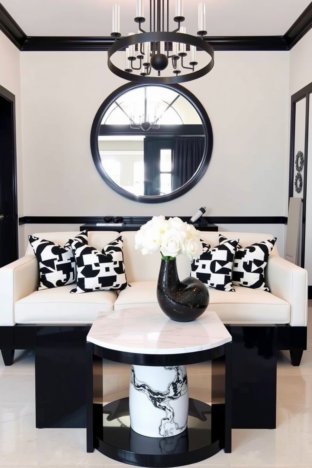 Striking black and white decorative pillows are arranged artfully on a luxurious cream-colored sofa. The pillows feature bold geometric patterns that create a stunning contrast against the soft fabric. The foyer is designed with a sleek black console table adorned with a white marble top. A large round mirror with a black frame hangs above the table, reflecting the light from a stylish chandelier above.