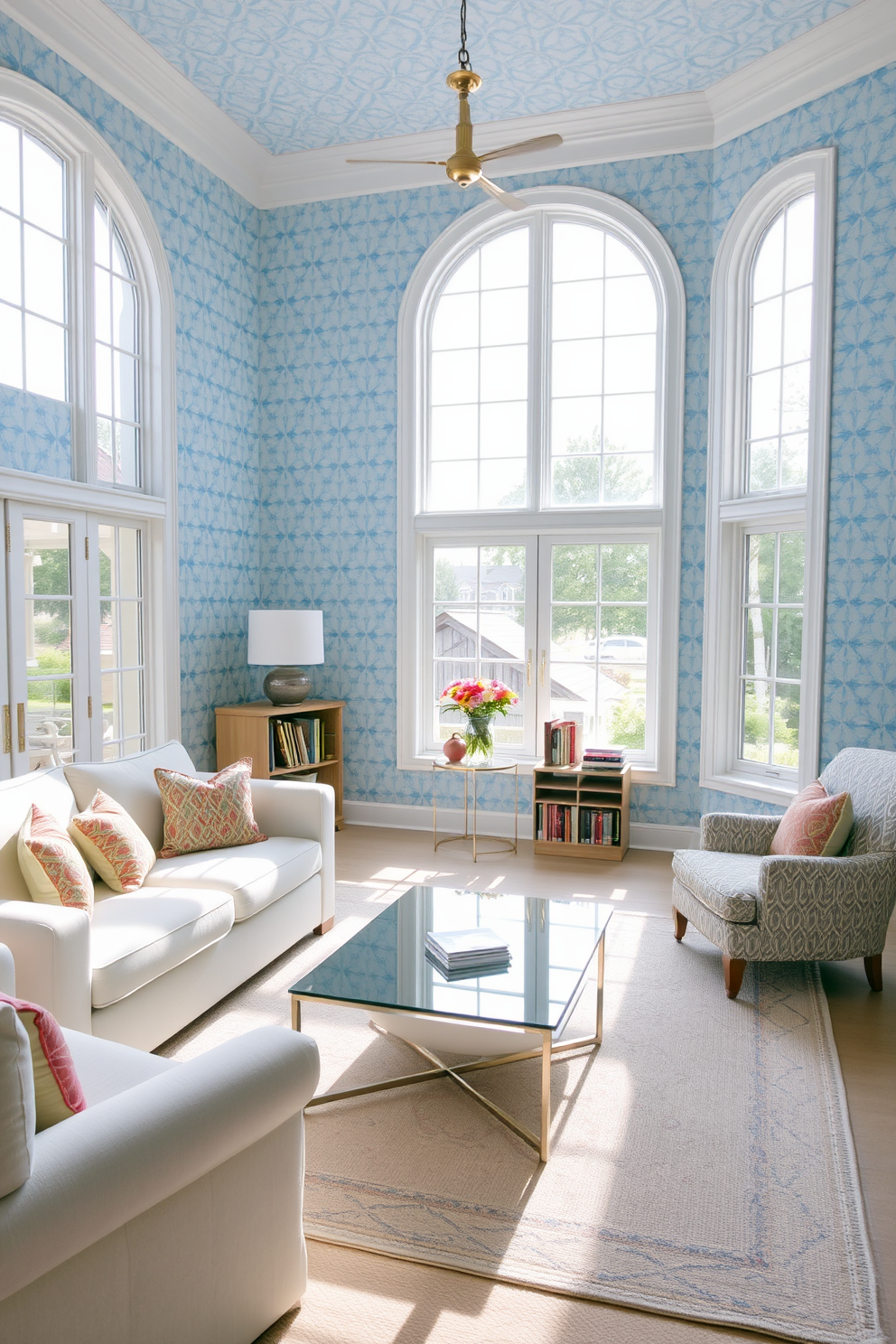 A serene living room adorned with pastel blue wallpaper that adds a soft touch to the space. The room features a plush white sofa with colorful accent pillows and a sleek glass coffee table in the center. Large windows allow natural light to flood the room, enhancing the airy atmosphere. A cozy reading nook is created with a comfortable armchair and a small bookshelf, completing the inviting ambiance.