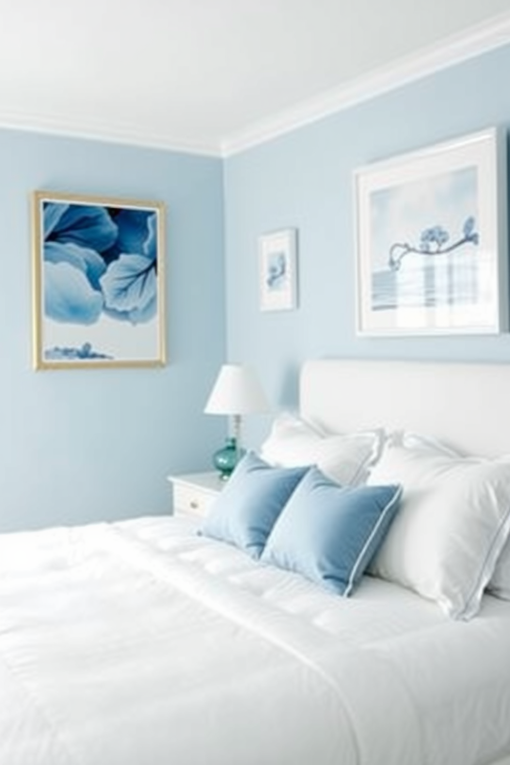 A serene blue bedroom featuring pastel blue art pieces that add a touch of subtle elegance to the space. The walls are painted in a soft pastel blue, complemented by a plush white bedspread and decorative pillows in varying shades of blue.