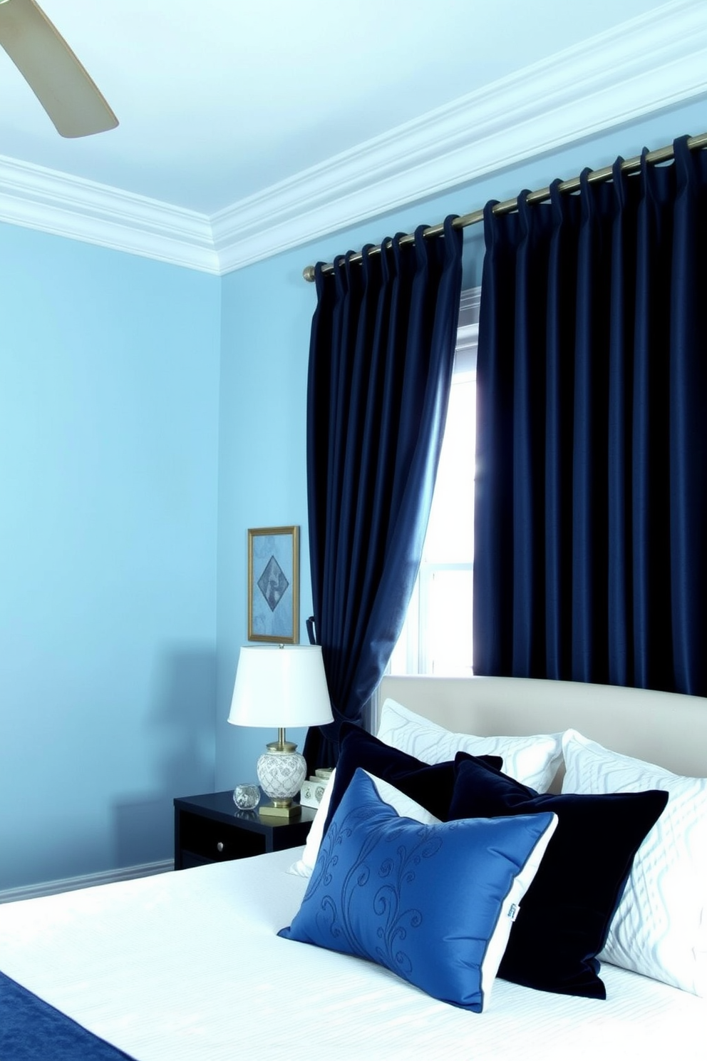 A serene blue bedroom featuring rich navy curtains that cascade elegantly from the ceiling to the floor. The walls are painted in a soft sky blue, complemented by a plush white bedspread and accent pillows in varying shades of blue.