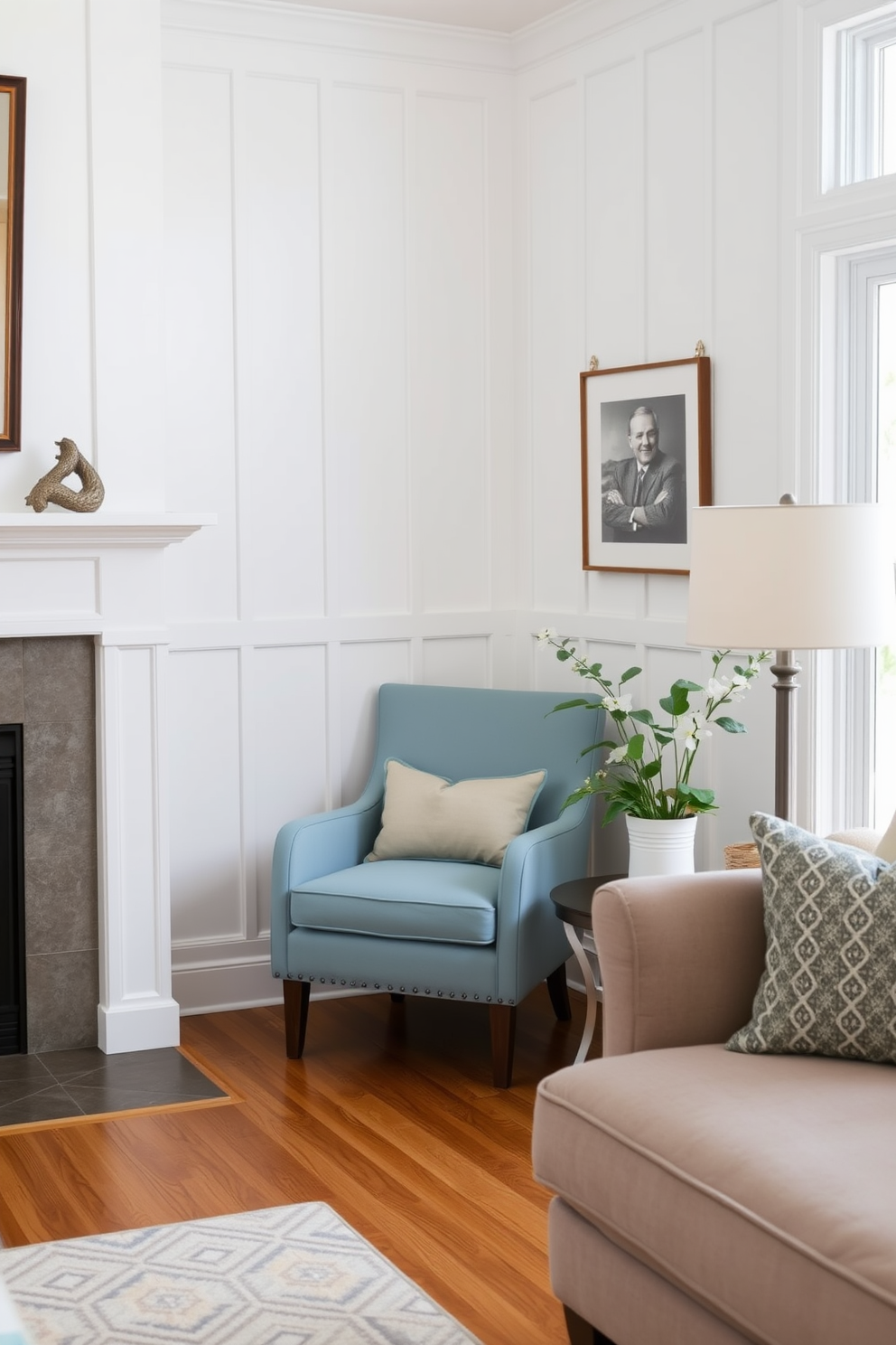 A cozy family room features a powder blue accent chair nestled in the corner, adding a touch of tranquility to the space. The walls are adorned with soft white paneling, while warm wooden flooring complements the inviting atmosphere.