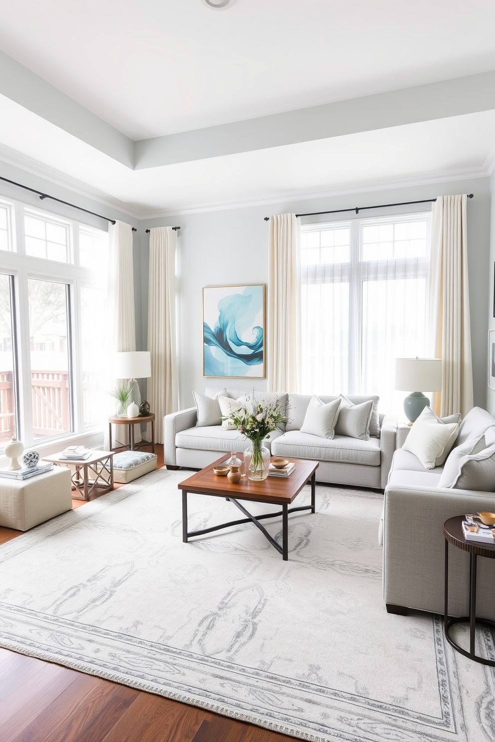 A cozy family room featuring pastel blue wall art that adds a soft touch to the space. The room includes a plush sectional sofa adorned with light gray cushions and a large area rug with subtle patterns. Natural light floods in through large windows dressed with sheer white curtains. A wooden coffee table sits in the center, surrounded by stylish side tables and decorative accents that enhance the inviting atmosphere.