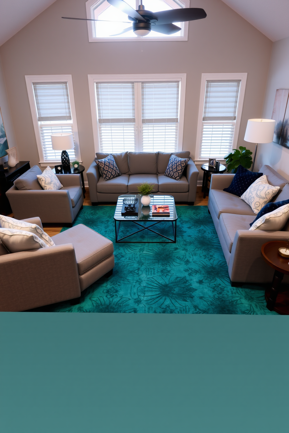 A cozy family room featuring a teal area rug that adds a pop of color to the space. Gray sofas are arranged around a modern coffee table, creating an inviting atmosphere for family gatherings.