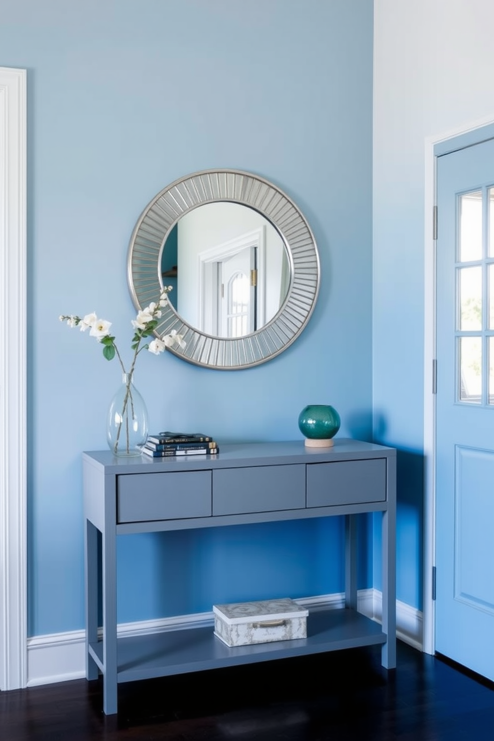 A serene foyer featuring a cerulean blue bench that includes integrated storage beneath the seat. The walls are adorned with soft white paneling, and a stylish area rug complements the calming color scheme.