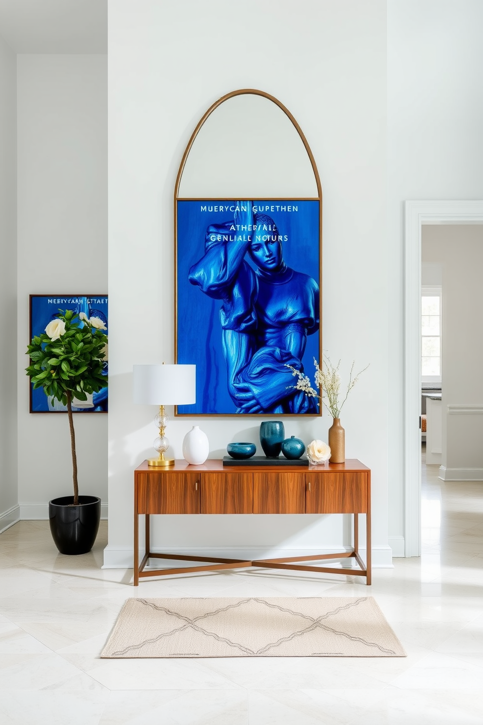 A stunning foyer featuring a dusty blue mirror with an ornate frame that serves as a focal point. The walls are painted in a soft white, and the floor is adorned with a rich hardwood finish that complements the mirror beautifully. Flanking the mirror are elegant sconces that provide warm lighting, enhancing the inviting atmosphere of the space. A plush area rug in muted tones lies beneath a stylish console table, which is decorated with curated accessories and a small potted plant.