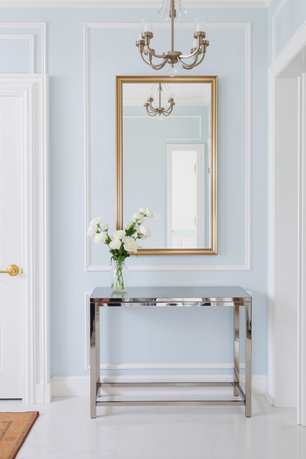 A bright foyer featuring light blue wallpaper adorned with delicate white trim creates a refreshing atmosphere. The space is enhanced by a sleek console table with a polished finish, complemented by a stylish mirror above it.