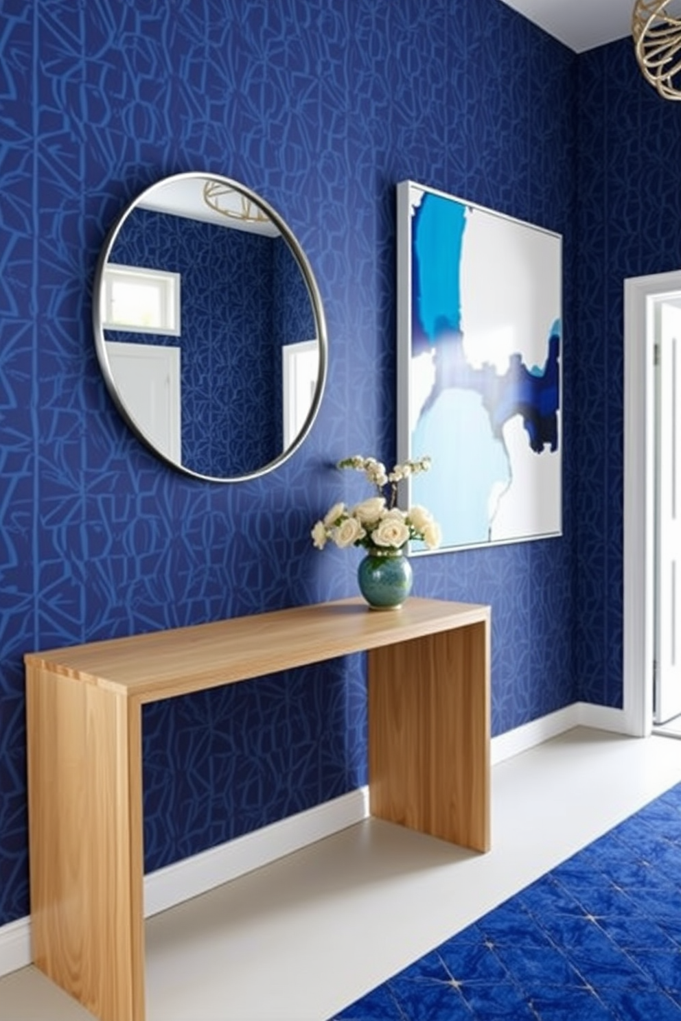 A striking foyer featuring geometric blue patterns creates a modern touch that is both inviting and stylish. The walls are adorned with a bold blue geometric wallpaper, complemented by a sleek console table in a contrasting light wood finish. A large round mirror with a thin metallic frame hangs above the console, reflecting the natural light that floods the space. A vibrant abstract artwork in shades of blue and white is displayed prominently on one wall, enhancing the contemporary aesthetic.