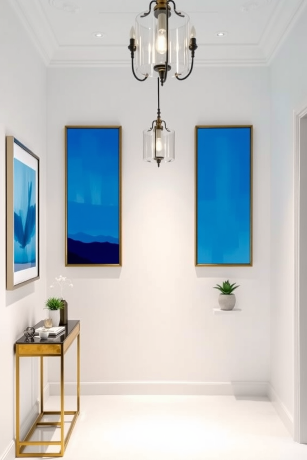 A serene foyer featuring subtle blue accents in the artwork frames. The walls are painted in a soft white, creating a fresh and inviting atmosphere. A stylish console table sits against the wall, adorned with decorative items and a small potted plant. Elegant lighting fixtures hang from the ceiling, casting a warm glow throughout the space.