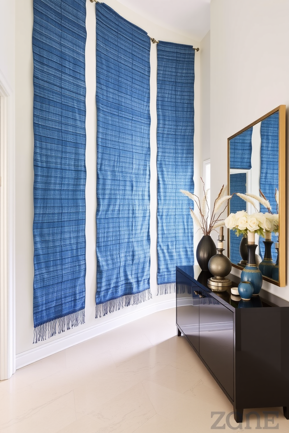 Bright blue door with contrasting hardware. The foyer features a sleek console table with a decorative mirror above it. The walls are painted in a soft white to enhance the brightness of the blue door. A stylish area rug in shades of blue and white adds warmth to the space.