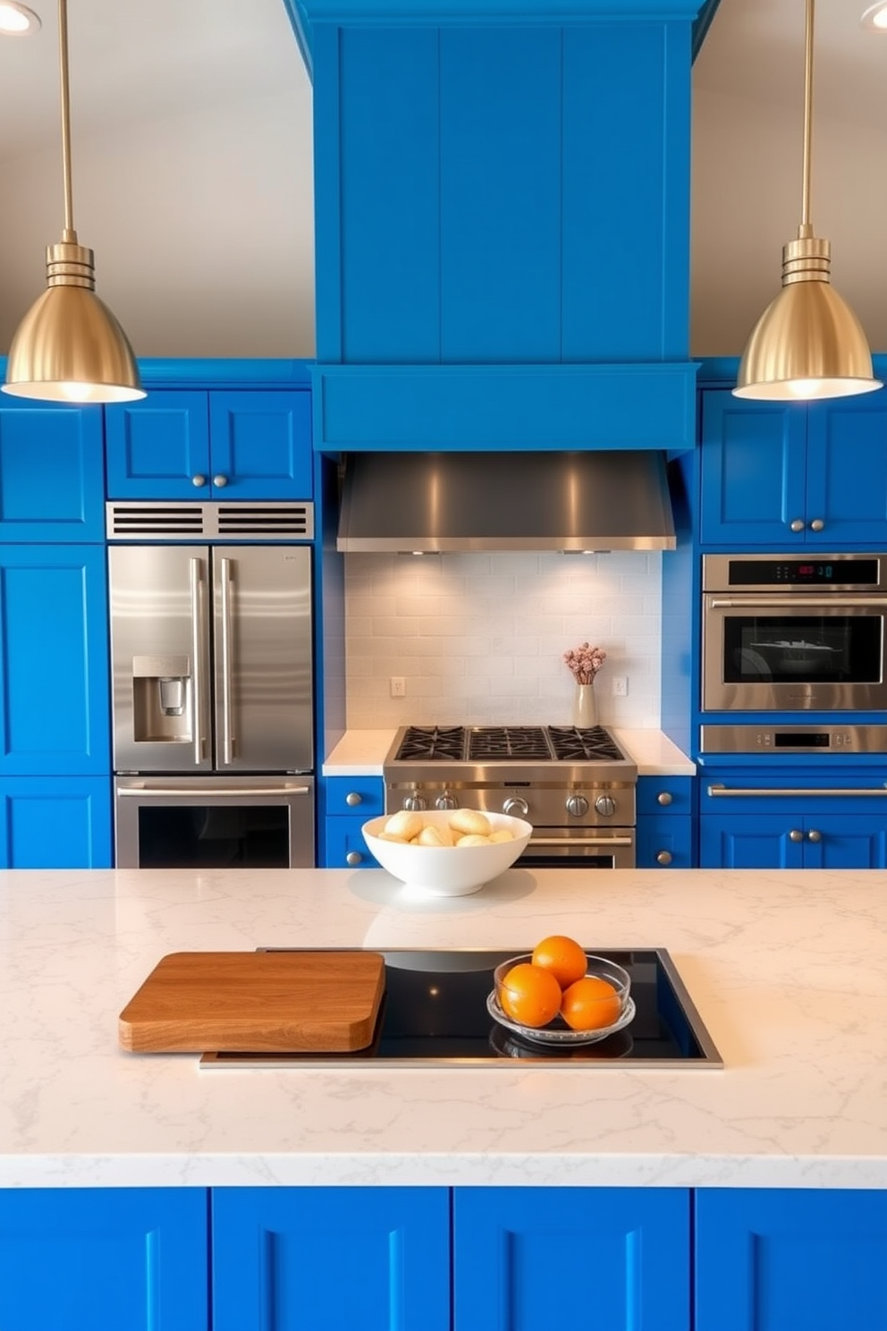 A cerulean blue kitchen features sleek stainless steel appliances that complement the vibrant cabinetry. The space is illuminated by pendant lights hanging above a large central island, creating a perfect area for cooking and entertaining.