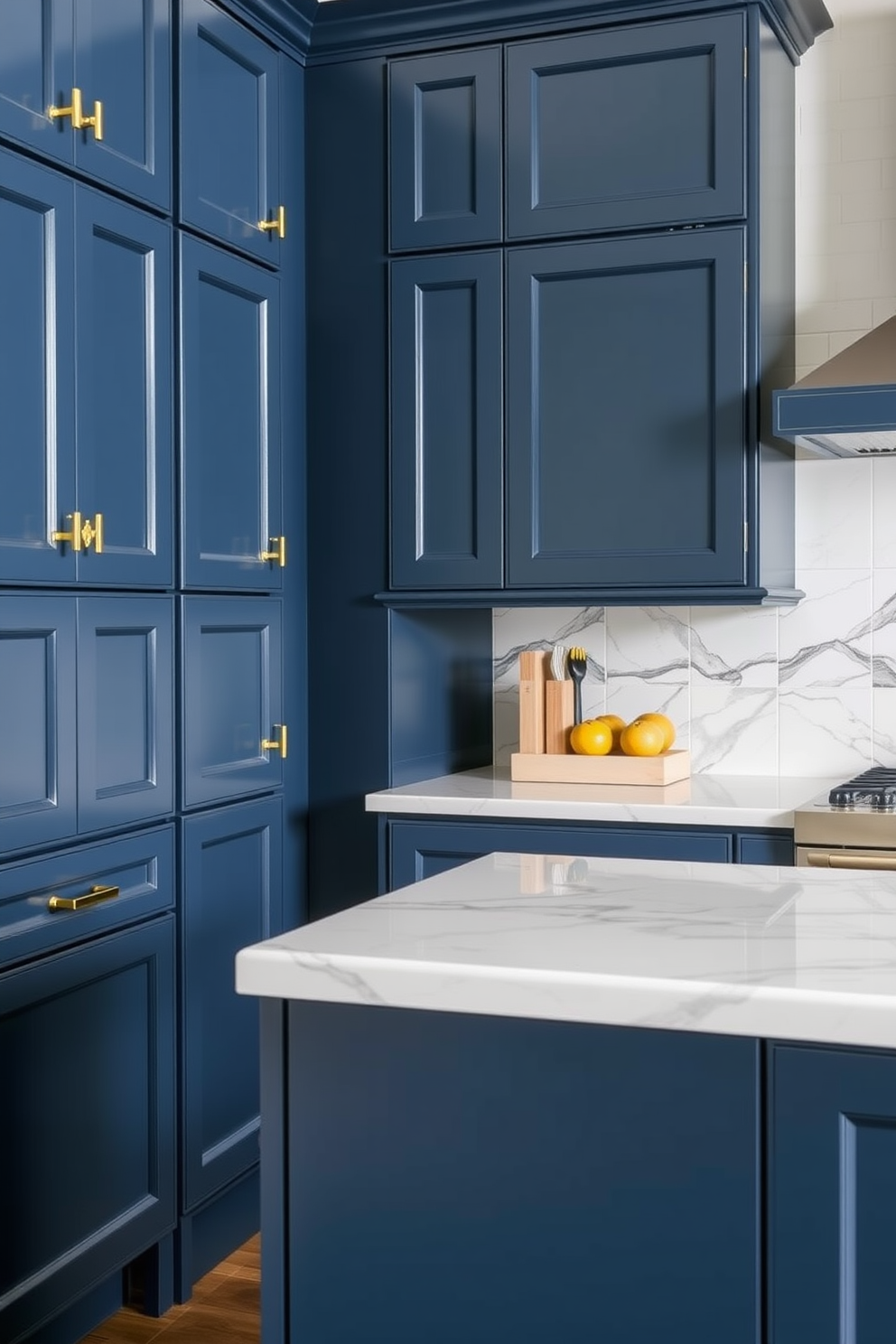 A modern kitchen featuring dark blue cabinets adorned with elegant brass hardware. The space is complemented by a white marble countertop and a stylish backsplash that adds a touch of sophistication.