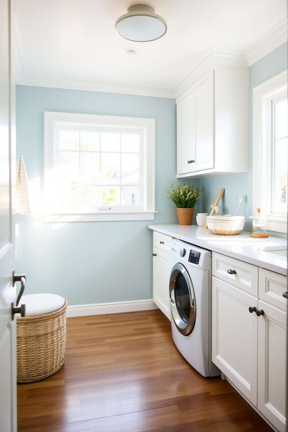 A bright and airy laundry room featuring white cabinetry with sleek lines and a coastal theme. The walls are painted in soft blue tones, complemented by nautical decor and natural light streaming in through large windows.