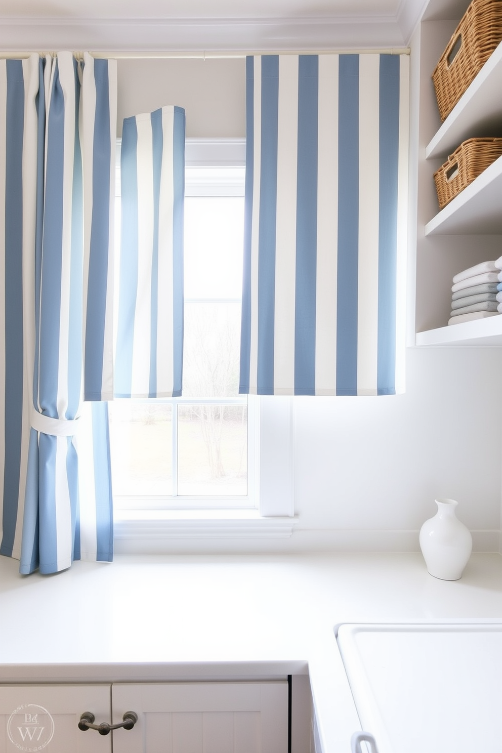 A bright and airy laundry room features blue and white striped curtains that gently frame a large window, allowing natural light to flood the space. The room includes a sleek white countertop for folding clothes, with open shelving above displaying neatly organized baskets and decorative items.