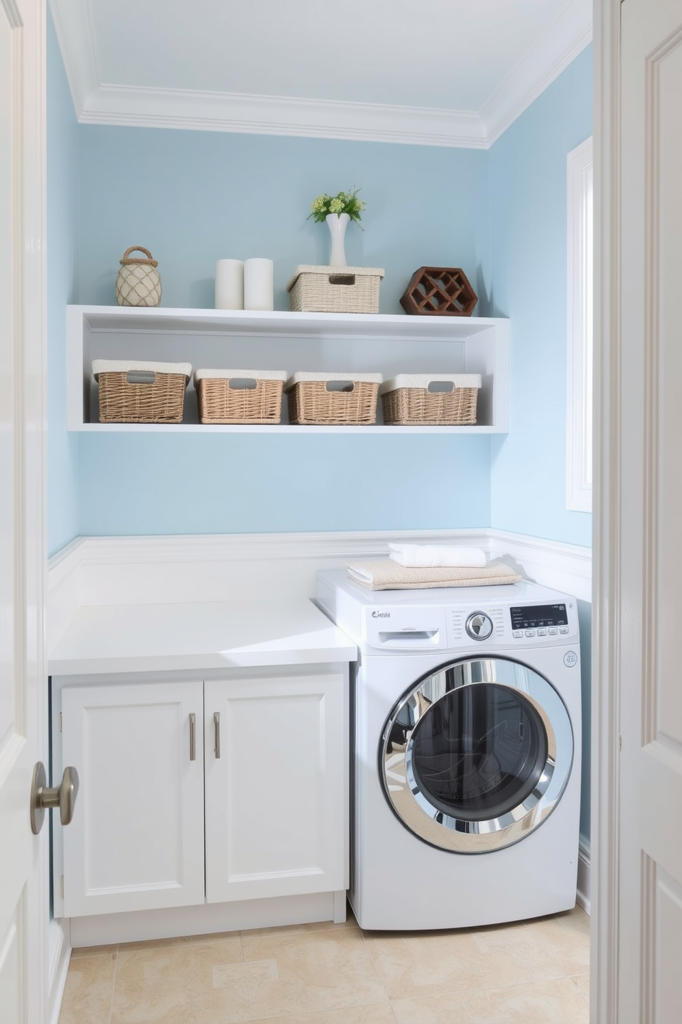 A bright and airy laundry room features light blue walls that create a calming atmosphere complemented by crisp white trim. The space includes a spacious white countertop for folding clothes, with open shelving above displaying neatly organized baskets and decorative items.