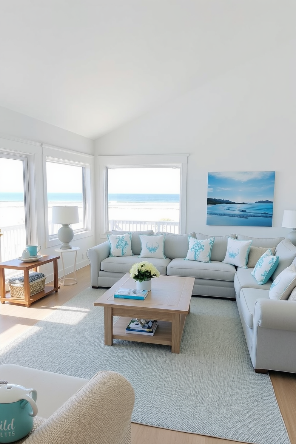 A bright and airy coastal living room features light blue accents throughout the space. Comfortable seating arrangements include a plush sectional sofa adorned with ocean-themed throw pillows and a light wood coffee table at the center. Large windows allow natural light to fill the room, offering a stunning view of the beach. The walls are painted in a soft white, complemented by light blue artwork that captures the essence of seaside living.