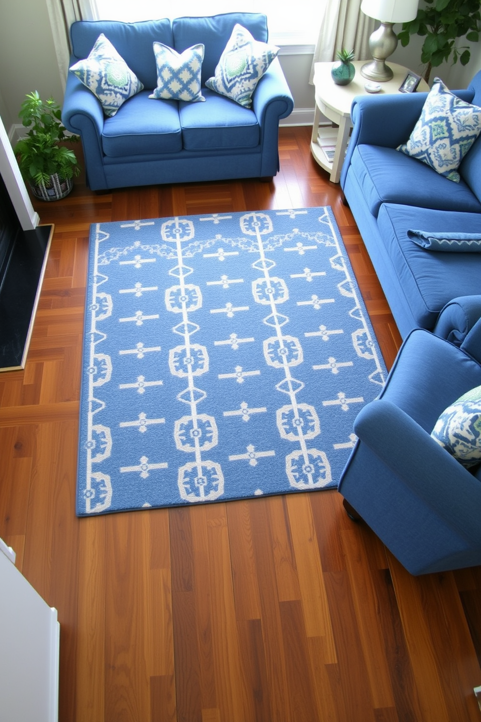 A cozy living room featuring a blue patterned area rug on a rich hardwood floor. The space is adorned with plush blue sofas and accent pillows that complement the rug, creating a harmonious and inviting atmosphere.