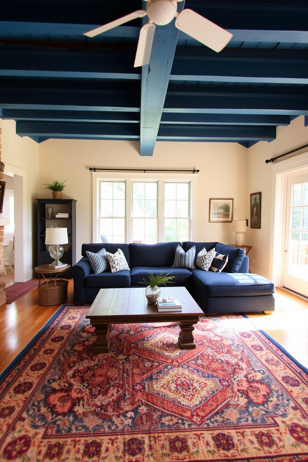 A serene living room featuring cool blue tones that evoke tranquility. The walls are painted in a soft sky blue, complemented by a plush navy sofa adorned with white and gray throw pillows. Natural light floods the space through large windows, enhancing the calming ambiance. A light wood coffee table sits on a textured area rug, while abstract artwork in shades of blue and white adorns the walls.