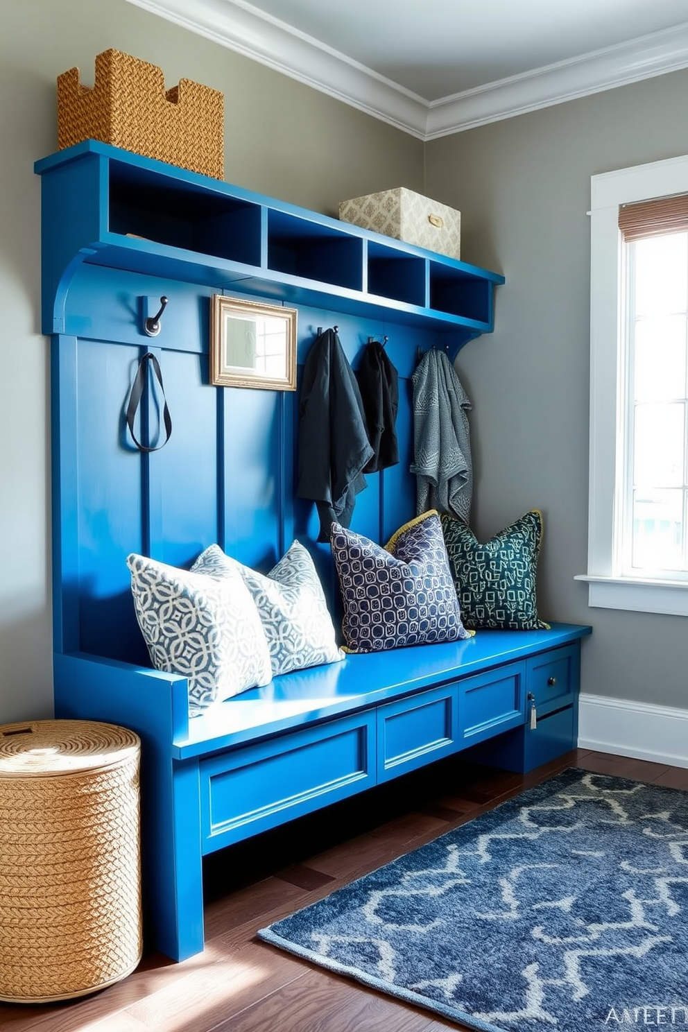 A light blue wainscoting creates a fresh and inviting atmosphere in the mudroom. The space features built-in storage benches and hooks for coats, complemented by a patterned rug that adds warmth and style.