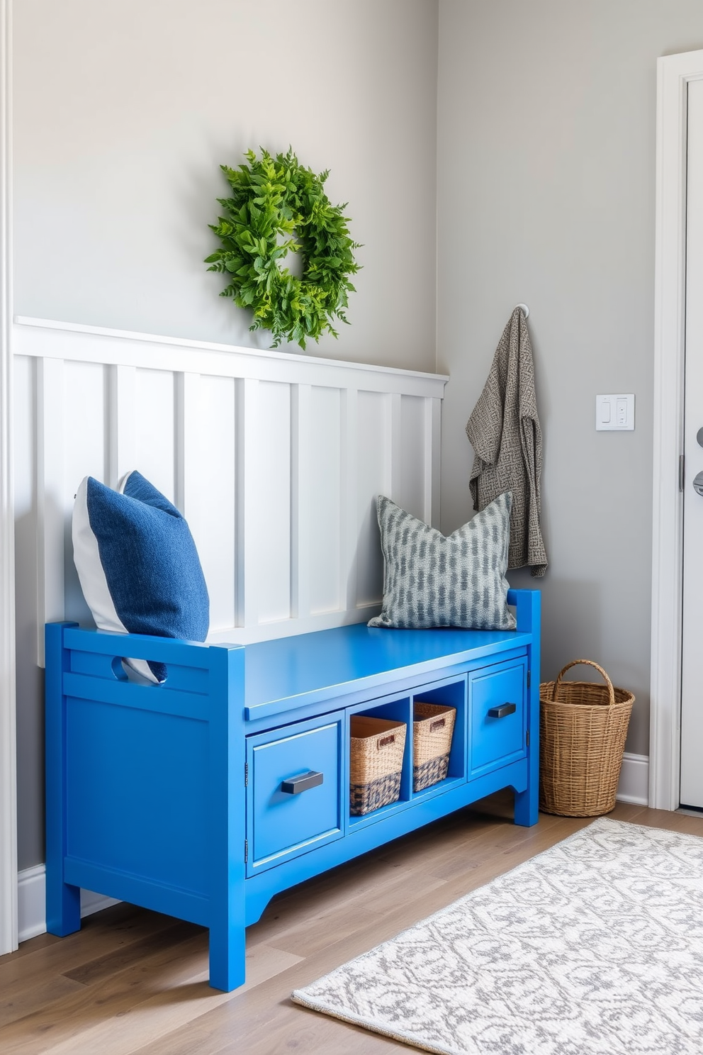 A serene mudroom design featuring sky blue patterned tile flooring that complements the overall aesthetic. The space is accented with white cabinetry and rustic wooden hooks for a charming yet functional look. Natural light floods the room through a large window, highlighting the clean lines and organized layout. A cozy bench with soft cushions provides a welcoming touch, inviting guests to relax as they enter.