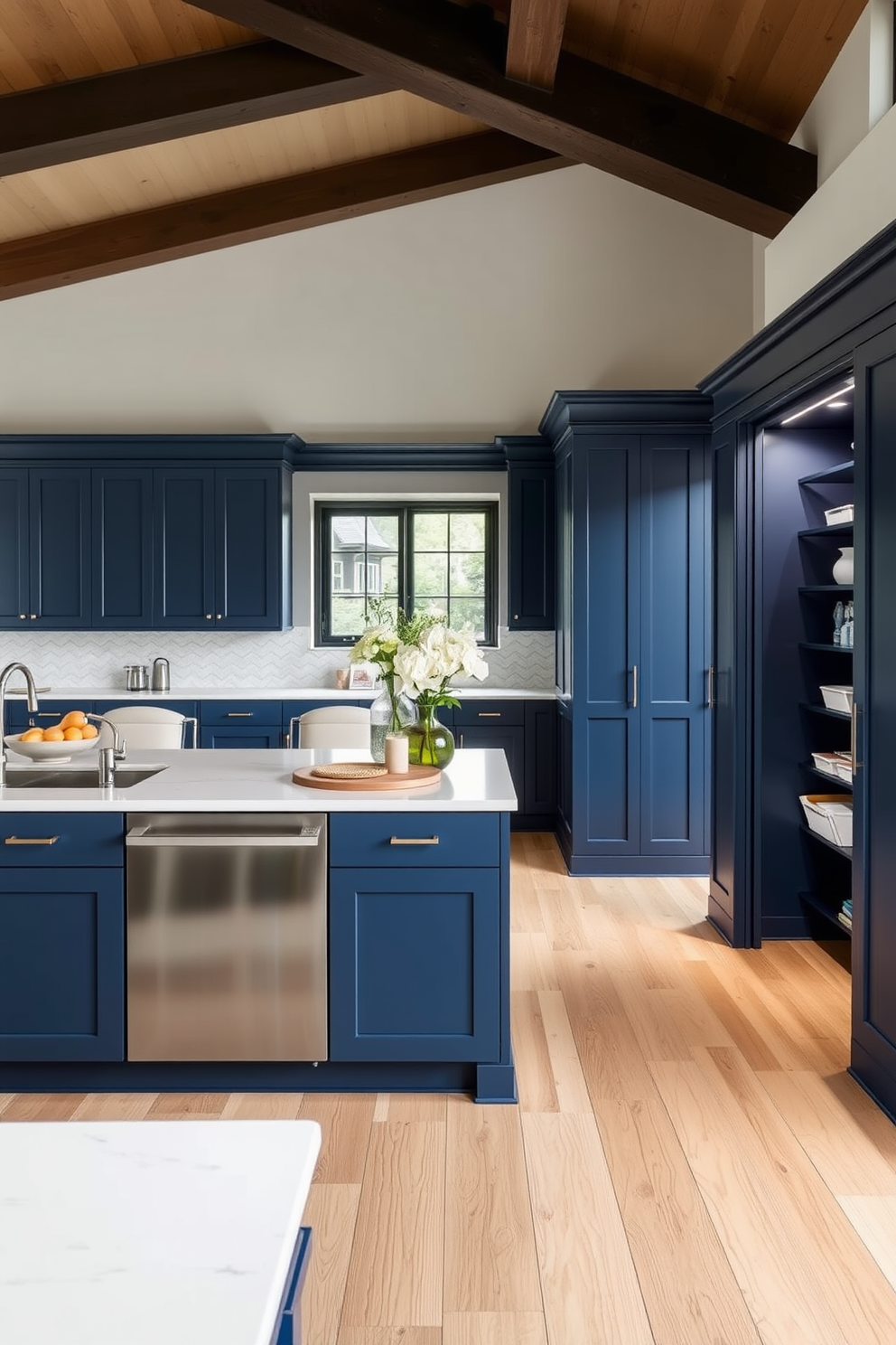 Light navy cabinetry creates a striking focal point in an open concept kitchen, blending seamlessly with a spacious living area. The pantry features sleek shelving and organized storage solutions, enhancing both functionality and style.