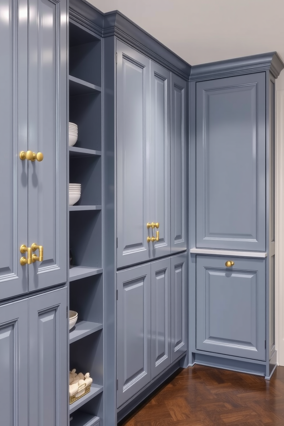 A serene pantry featuring muted blue cabinetry complemented by elegant gold fixtures. The cabinets are adorned with intricate detailing, creating a sophisticated and inviting atmosphere.