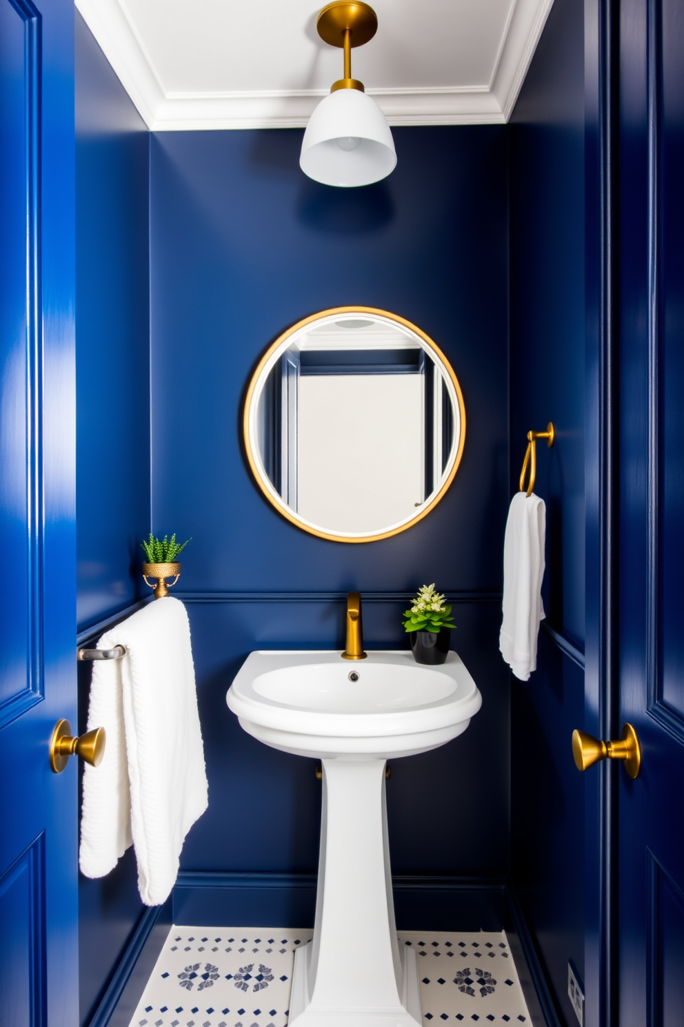 A striking blue powder room with deep navy walls that create a dramatic atmosphere. The bright lighting enhances the richness of the color, making the space feel both elegant and inviting. The room features a sleek white pedestal sink paired with a stylish round mirror framed in brushed gold. Decorative elements include a chic gold towel rack and a small potted plant on the countertop for a touch of greenery.