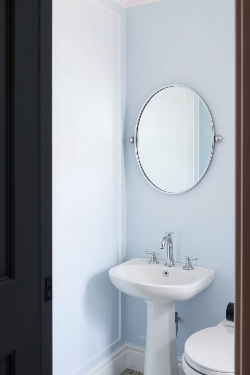 Bright sky blue walls with white trim create a refreshing and airy atmosphere in the powder room. A sleek white pedestal sink is complemented by a round mirror with a delicate silver frame, enhancing the room's brightness. To the left, a small wooden shelf displays neatly folded towels and a decorative plant. The floor features white hexagonal tiles that add a touch of elegance and contrast beautifully with the vibrant wall color.