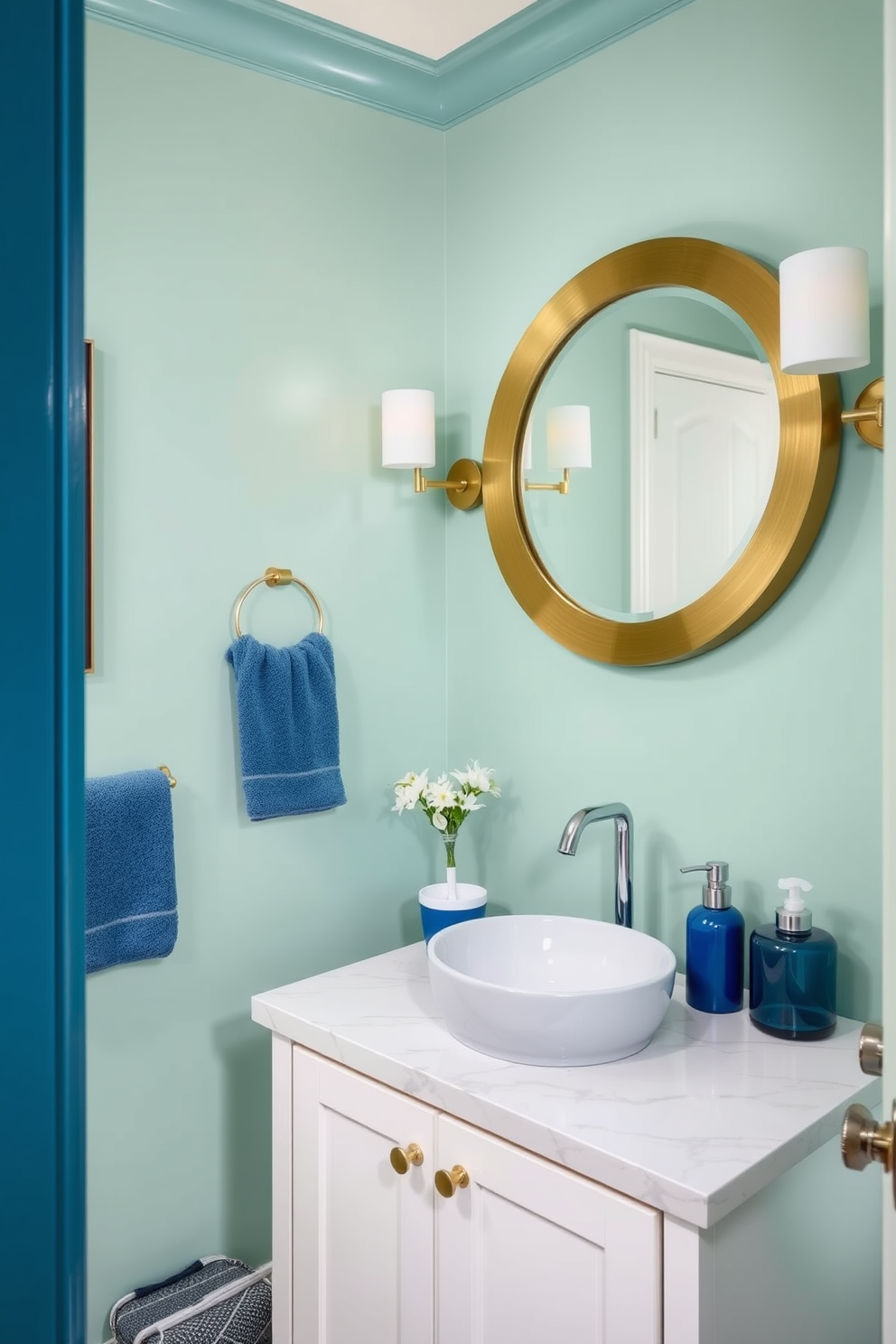 A serene powder room featuring a seafoam green and blue color blend. The walls are painted in a soft seafoam green, complemented by blue accents in the decor and accessories. A sleek white vanity with a marble countertop holds a stylish sink. Above the vanity, a round mirror with a brushed gold frame enhances the elegant atmosphere.