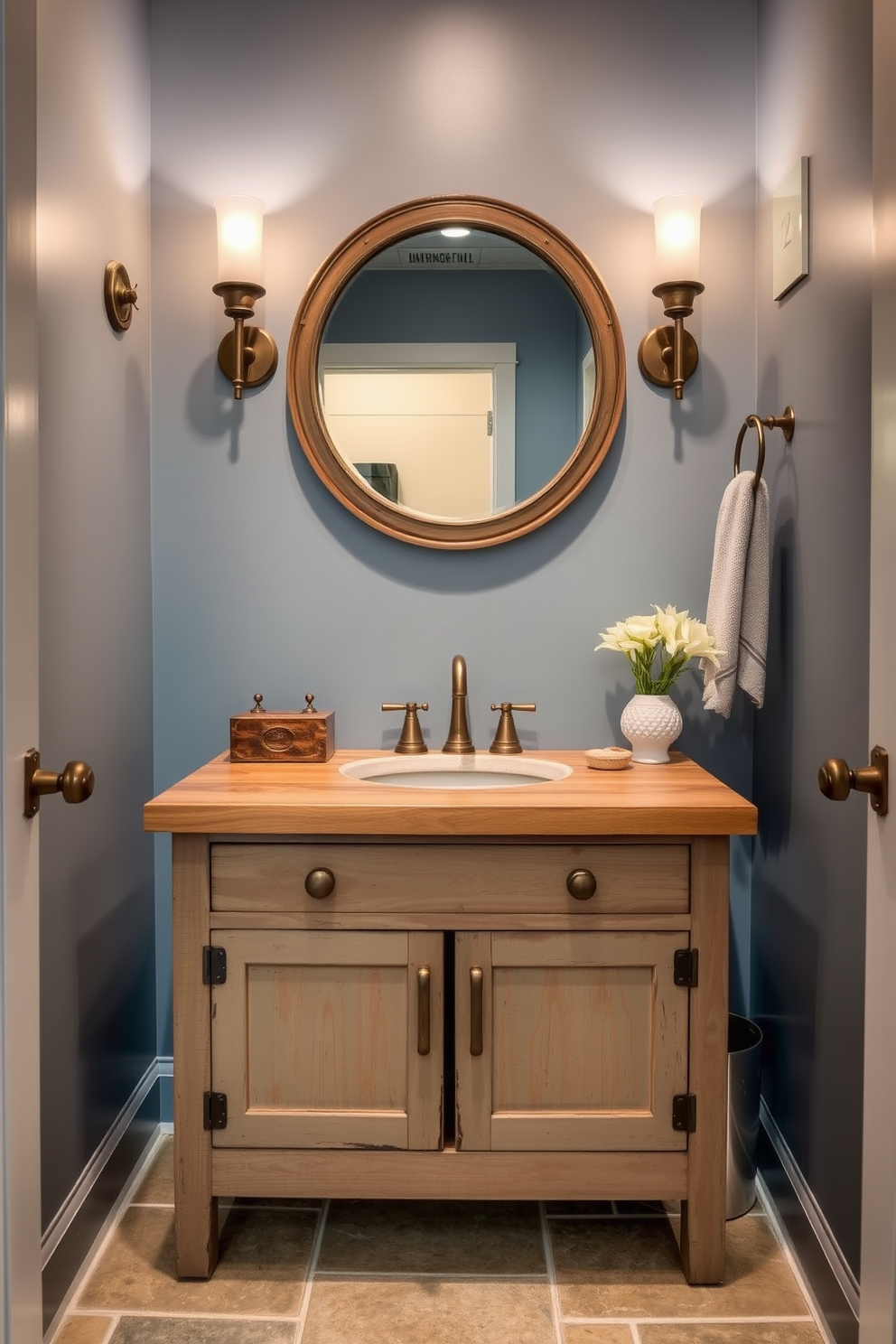 A stylish blue powder room featuring artful blue abstract prints adorning the walls. The space includes a sleek white pedestal sink and a modern gold faucet, complemented by a chic round mirror above the sink.