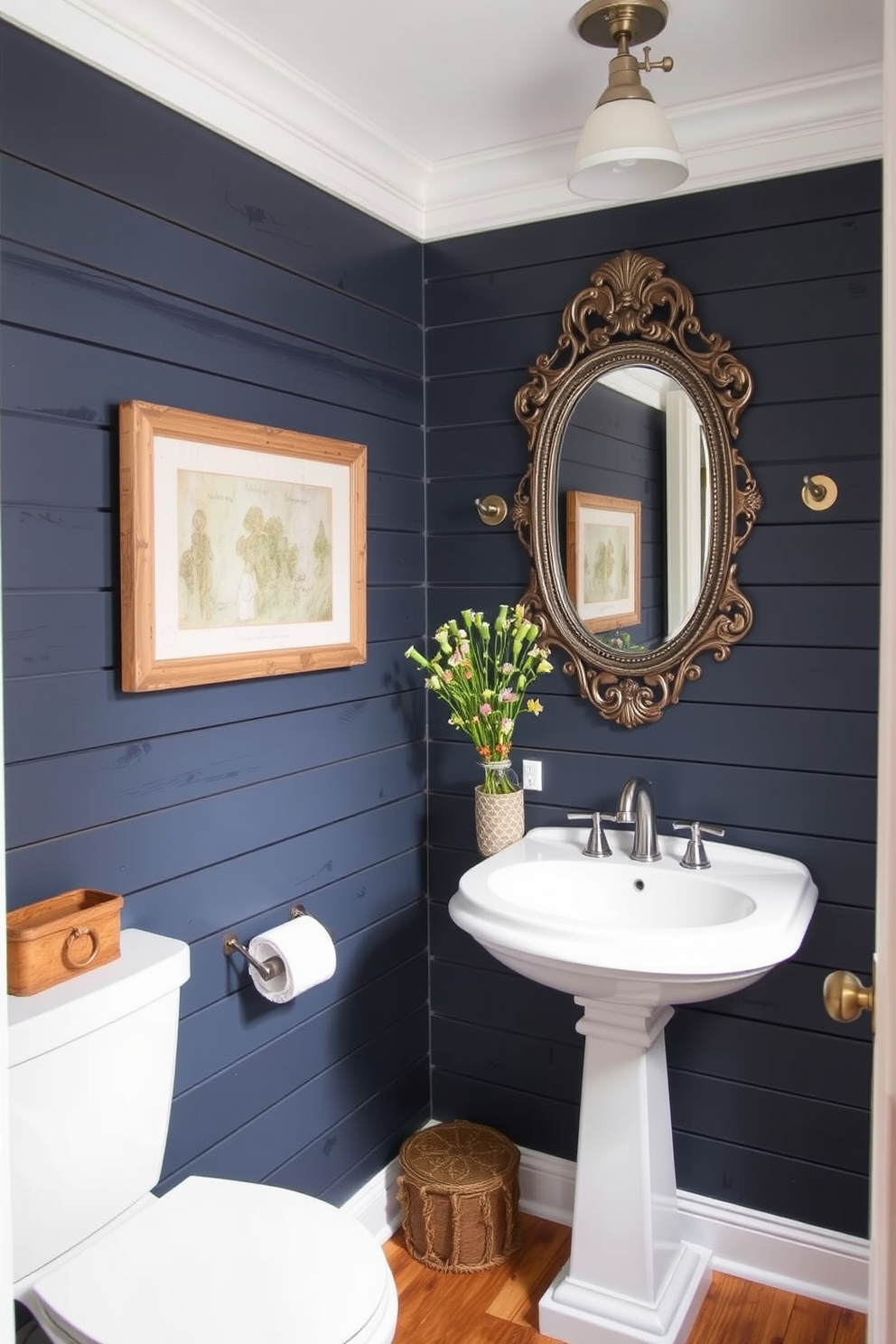 A cozy powder room with dark blue shiplap walls that evoke rustic charm. The space features a white pedestal sink and a vintage-style mirror with an ornate frame, creating an inviting atmosphere.