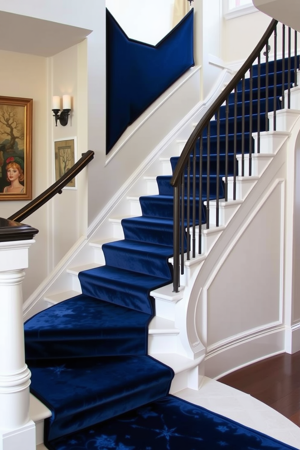 A stunning staircase features a deep blue velvet runner that adds a touch of luxury to the design. The staircase itself is elegantly curved, with white risers that contrast beautifully against the rich fabric of the runner. The walls alongside the staircase are painted in a soft cream color, enhancing the overall brightness of the space. Stylish wall sconces provide warm lighting, highlighting the plush texture of the velvet as you ascend.